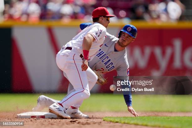 Cody Bellinger of the Chicago Cubs steals second base past Spencer Steer of the Cincinnati Reds in the sixth inning during game one of a doubleheader...