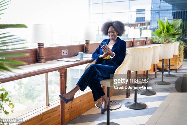 kenyan businesswoman looking at smart phone - nairobi county stock pictures, royalty-free photos & images