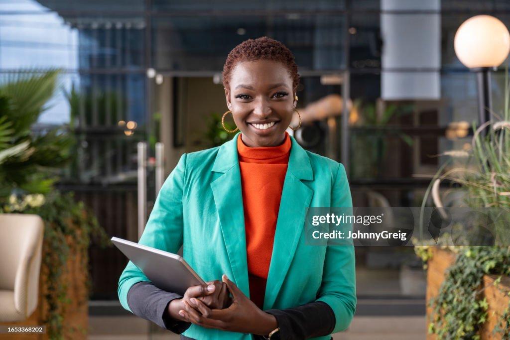 Atrium portrait of cheerful Kenyan business professional