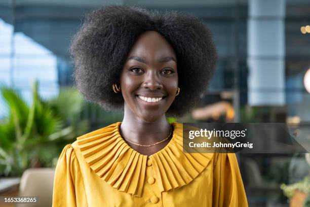 open-air portrait of well-dressed kenyan businesswoman - black gold blouse stock pictures, royalty-free photos & images