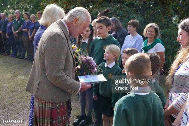 King Charles III and Queen Camilla meet estate staff and members of the public as they depart Crathie Parish Church following a church service to...