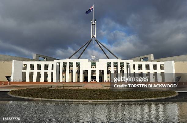 The Australian national flag flies over Parliament House in Canberra on June 20, 2011. The building was designed by Mitchell/Giurgola Architects and...