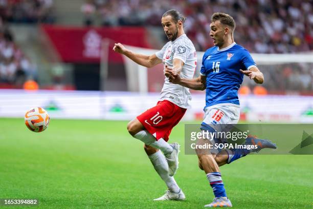 Grzegorz Krychowiak of Poland and Gunnar Vatnhamar of Faroe Islands are seen in action during the UEFA EURO 2024 qualifying match between Poland and...