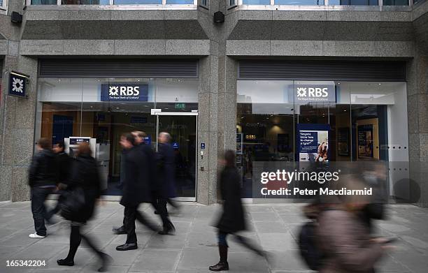 People walk past a branch of The Royal Bank of Scotland on April 3, 2013 in London, England. Investors have launched a compensation claim against The...