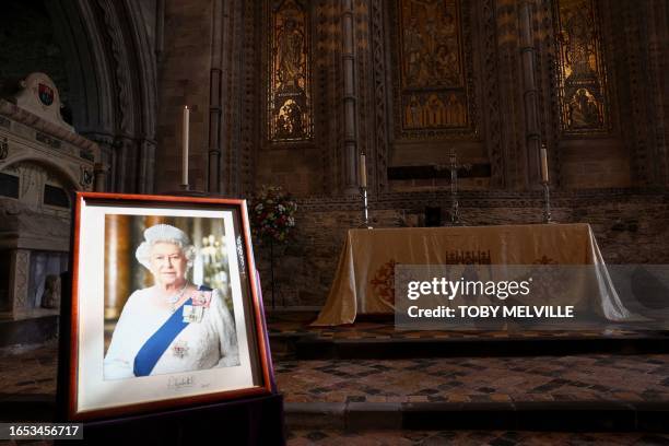 Portrait of Britain's Queen Elizabeth is displayed in St Davids Cathedral ahead of the arrival of Britain's Prince William, Prince of Wales and...