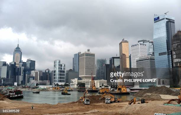 Worker walks if front of high rise buildings where land reclamation work is underway in Hong Kong on May 26, 2008. More than ten percent of Hong...