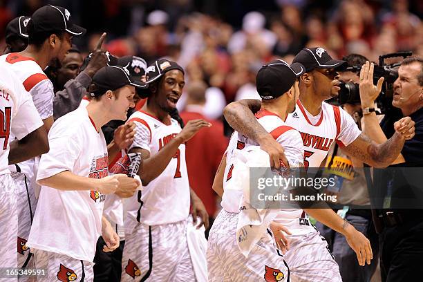 Players of the Louisville Cardinals celebrate following their victory against the Duke Blue Devils during the Midwest Regional Final of the 2013 NCAA...