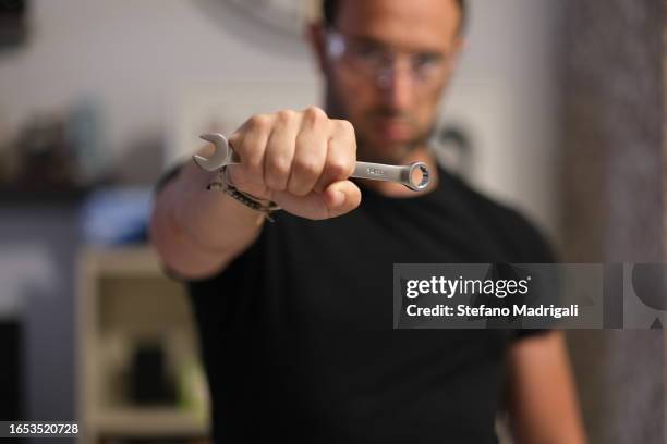 man with hex wrench, housework - holding wrench stock pictures, royalty-free photos & images
