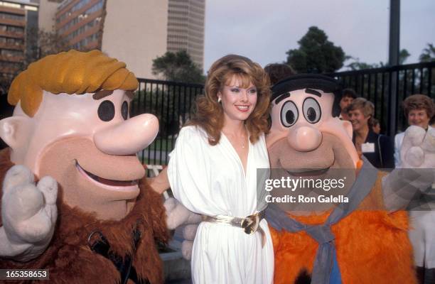 Barney Rubble, actress Rebecca Holden and Fred Flintstone attend the NBC Television Affiliates Party on May 16, 1983 at George C. Page Museum, La...