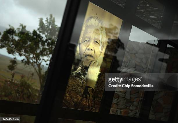 An image of former South African President Nelson Mandela is pasted into a window at the Nelson Mandela Museum's Youth and Heritage Center April 2,...