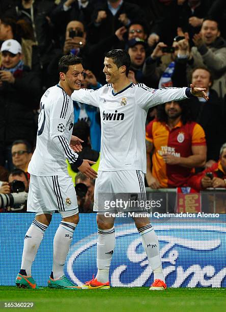 Cristiano Ronaldo of Real Madrid celebrates scoring the opening goal with Mesut Oezil during the UEFA Champions League Quarter Final first leg match...