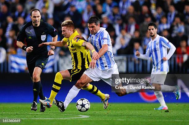 Marco Reus of Borussia Dortmund duels for the ball with Jeremy Toulalan of Malaga CF during the UEFA Champions League quarter-final first leg match...