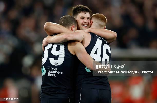Alex Cincotta, Nic Newman and Matthew Cottrell of the Blues celebrate during the 2023 AFL First Elimination Final match between the Carlton Blues and...