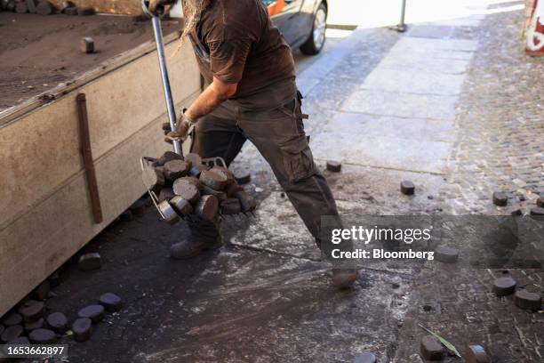 Worker unloads a delivery of lignite briquettes to a residential address in Berlin, Germany, on Friday, Sept. 8, 2023. ECB officials meeting Sept. 14...