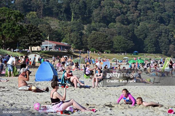 People enjoy the hot, sunny weather on Silver Sands beach, as many parts of the UK continue to bask in late summer sunshine and high temperatures, on...