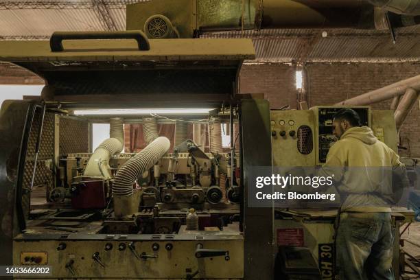 Worker cuts wood boards used in the production of furniture at a woodshop in Machagai, Chaco province, Argentina, on Wednesday, Sept. 6, 2023. The...