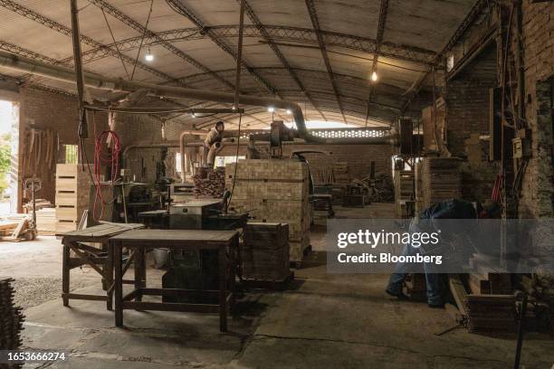 Workers assemble wood pieces into boards used in the production of furniture at a woodshop in Machagai, Chaco province, Argentina, on Wednesday,...