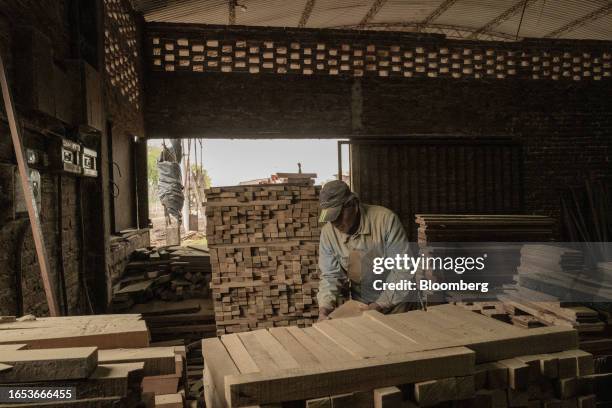 Worker inspects wood boards used in the production of furniture at a woodshop in Machagai, Chaco province, Argentina, on Wednesday, Sept. 6, 2023....