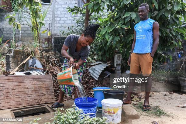 Person pours water from a well in a bucket in the district of Bellevue 2, in Libreville on September 8, 2023.