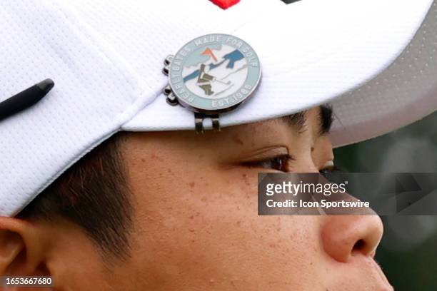 Close up of the ball marker stating "Pearly Gates Made For Golf" worn on the bill of the cap of LPGA golfer Peiyun Chien as she walks the 15th hole...
