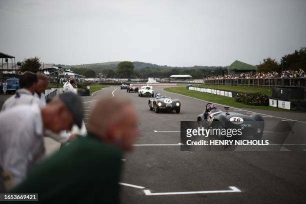 Classic race cars get ready for a race on the opening day of the Goodwood Revival meeting 2023, north of Chichester in southern England on September...