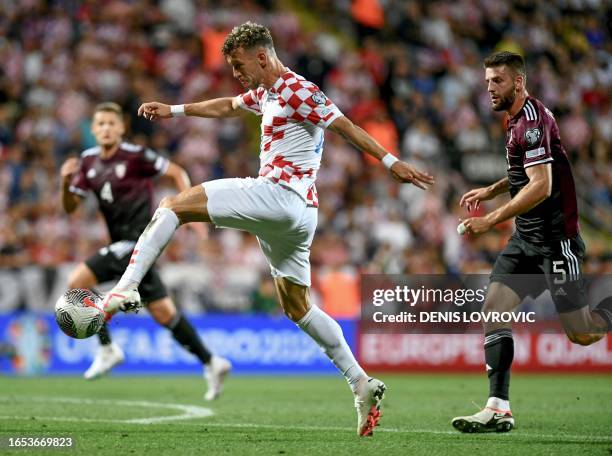 Croatia's forward Ivan Perisic shoots during the UEFA Euro 2024 football tournament group D qualification football match between Croatia and Latvia...