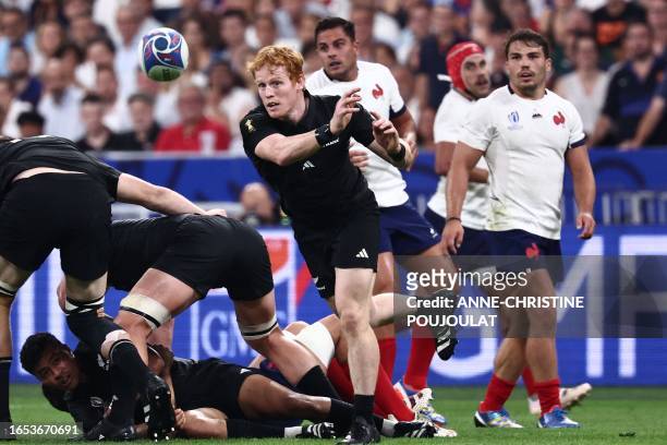 New Zealand's fly-half Finlay Christie releases the ball from a ruck during the France 2023 Rugby World Cup Pool A match between France and New...