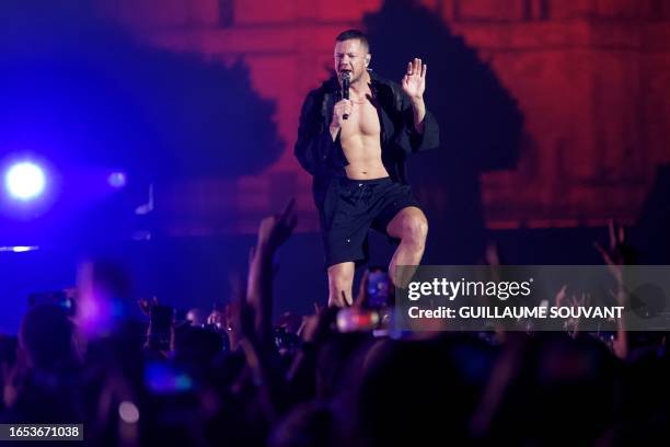 Rock band Imagine Dragons' lead singer Dan Reynolds performs on stage in front of the Chateau de Chambord castle on September 8, 2023 in Chambord,...