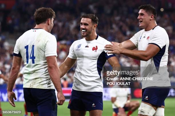 France's full-back Melvyn Jaminet celebrates with France's flanker Paul Boudehent and France's right wing Damian Penaud after scoring a try during...