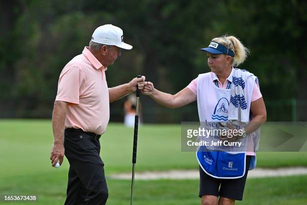 Billy Mayfair celebrates with his caddie after making a birdie putt on the eighth hole during the first round of the Ascension Charity Classic at...