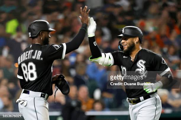 Yoan Moncada of the Chicago White Sox celebrates with Luis Robert Jr. #88 after hitting a two-run home run against the Detroit Tigers during the...