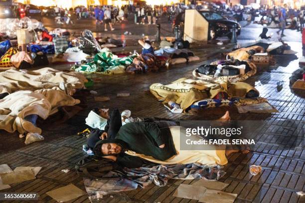 Residents take shelter ouside at a square following an earthquake in Marrakesh on September 9, 2023. Nearly 300 people were killed after a powerful...