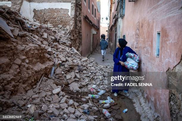 Woman looks at the rubble of a building in the earthquake-damaged old city in Marrakesh on September 9, 2023. A powerful earthquake that shook...
