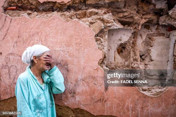 Woman reacts standing infront of her earthquake-damaged house in the old city in Marrakesh on September 9, 2023. A powerful earthquake that shook...