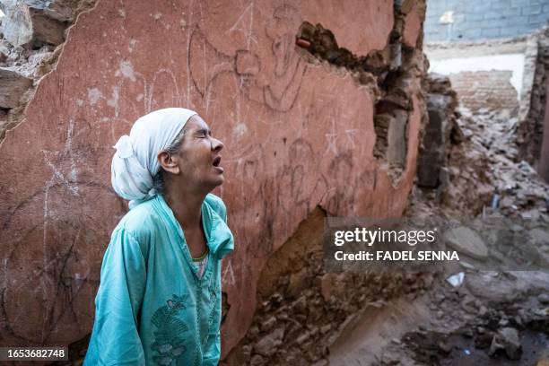 Woman reacts standing infront of her earthquake-damaged house in the old city in Marrakesh on September 9, 2023. A powerful earthquake that shook...