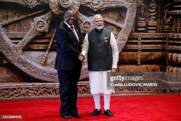 South Africa's President Cyril Ramaphosa and India's Prime Minister Narendra Modi shake hands ahead of the G20 Leaders' Summit in New Delhi on...