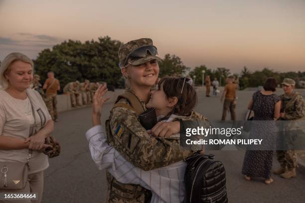 Ukrainian female cadet is greeted by relatives and friends after a ceremony for taking the military oath at The National Museum of the History of...