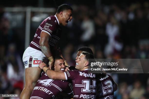 Raymond Tuaimalo Vaega of the Sea Eagles celebrates the try scored by Gordon Chan Kum Tong of the Sea Eagles during the round 27 NRL match between...