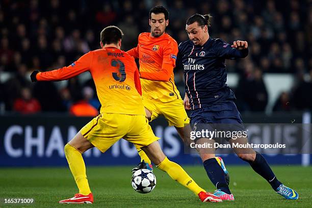 Zlatan Ibrahimovic of PSG and Gerard Pique and Sergio Busquets of Barcelona battle for the ball during the UEFA Champions League Quarter Final match...