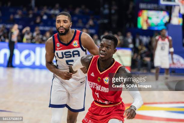Mikal Bridges of the United States and Dennis Schroder of Germany seen in action during the semifinals of the FIBA Basketball World Cup 2023 between...