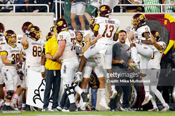 Chris Parker of the Central Michigan Chippewas celebrates with teammates after scoring a touchdown in the second quarter against the Michigan State...