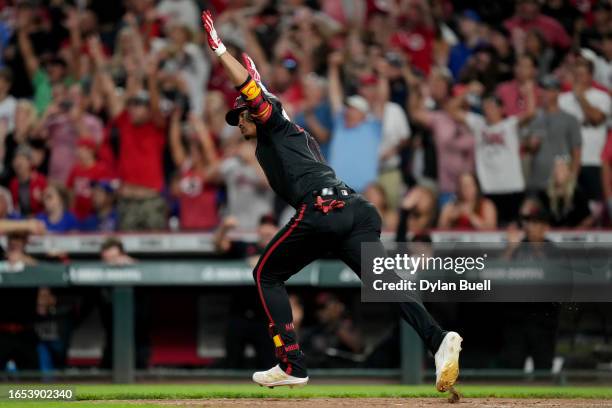 Noelvi Marte of the Cincinnati Reds celebrates after hitting a walk-off single in the ninth inning to beat the Chicago Cubs 3-2 during game two of a...