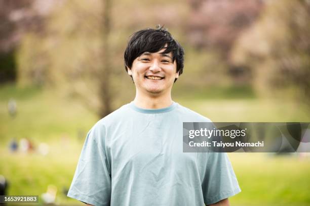 a portrait of a japanese man who came to a spring park. - japanse etniciteit stockfoto's en -beelden