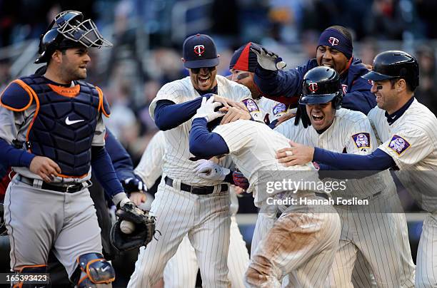 Alex Avila of the Detroit Tigers looks on as the Minnesota Twins celebrate a walk off double during the ninth inning of the game on April 3, 2013 at...