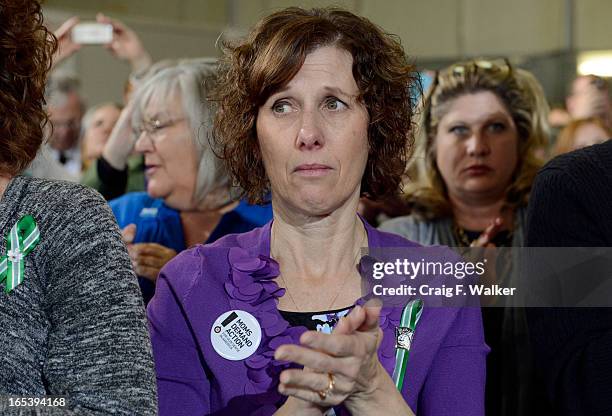 Jane Dougherty listens to President Barack Obama during a forum at the Denver Police Academy in Denver, CO April 03, 2013. The siblings sister, Mary...