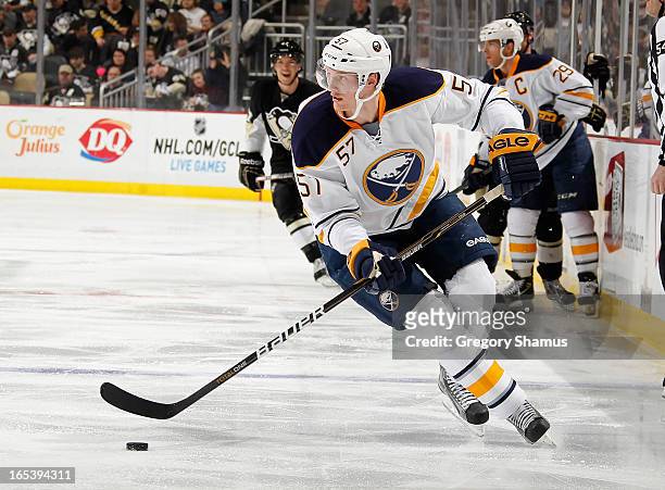 Tyler Myers of the Buffalo Sabres moves the puck against the Pittsburgh Penguins on April 2, 2013 at Consol Energy Center in Pittsburgh, Pennsylvania.