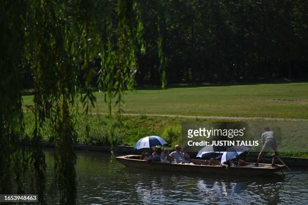 People enjoy the sunshine while punting on the River Cam in Cambridge, north of London on September 9 as the late summer heatwave continues.