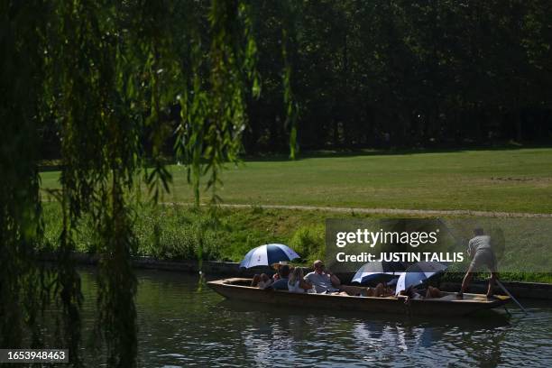 People enjoy the sunshine while punting on the River Cam in Cambridge, north of London on September 9 as the late summer heatwave continues.