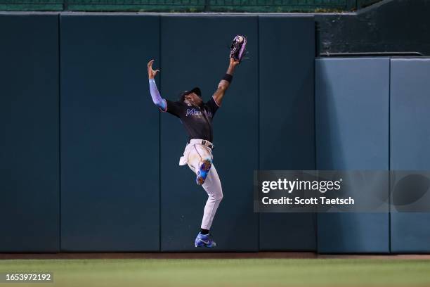Jazz Chisholm Jr. #2 of the Miami Marlins makes a catch at the wall to retire Riley Adams of the Washington Nationals during the eleventh inning at...