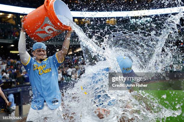 Willy Adames of the Milwaukee Brewers dumps water over Owen Miller after a 7-5 win over the Philadelphia Phillies at American Family Field on...